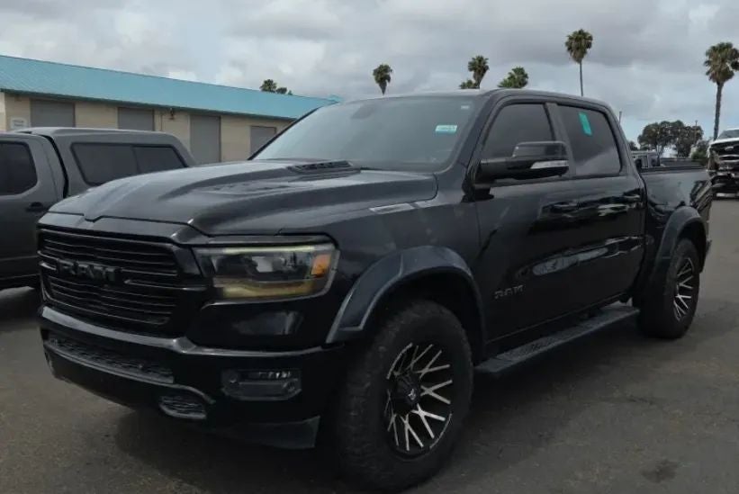 2019 RAM 1500 Laramie in Diamond Black Crystal Pearlcoat — front three-quarter view