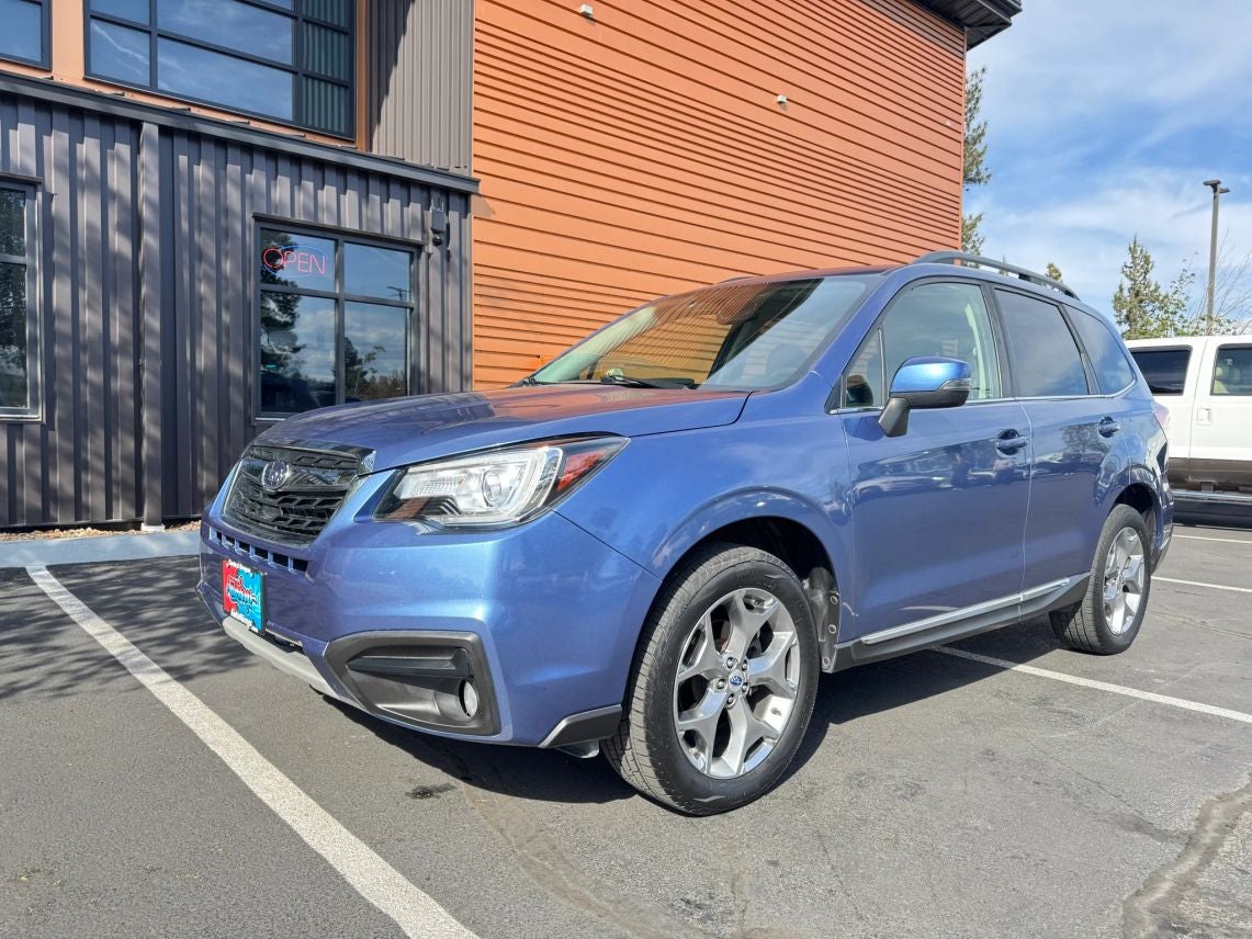 2017 Subaru Forester 2.5i Touring in Quartz Blue Pearl — front three-quarter view