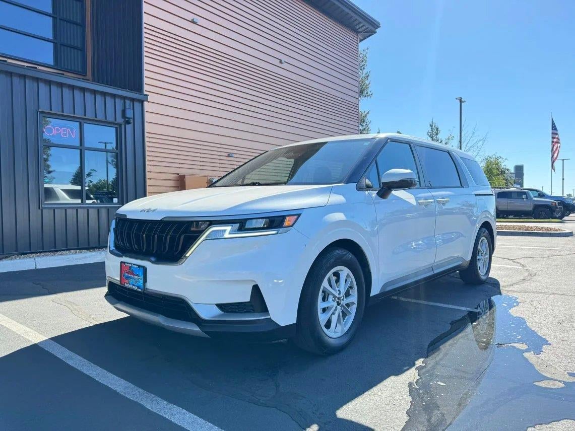 2022 Kia Carnival LXS in Snow White Pearl — front three-quarter view